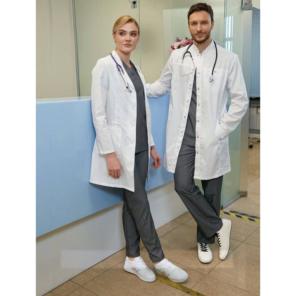 Two healthcare professionals wearing white medical coats and grey trousers at a clinic reception