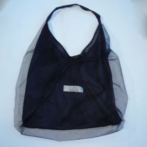 Black shopping bag with a sheer tulle outer layer, broad handles and a Raputa label